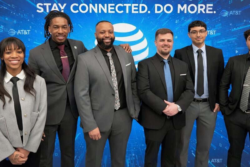 Six Empire Acquisitions representatives in front of a client brand backdrop